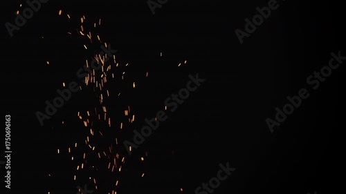 Slow motion of sparks and embers from campfire flying over black background