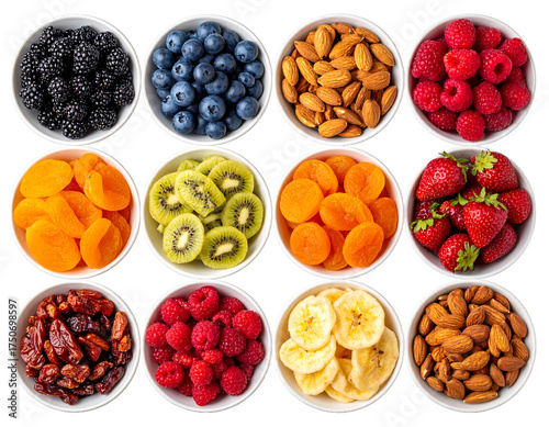 Assortment of fresh and dried fruits and nuts in white bowls isolated on transparent background