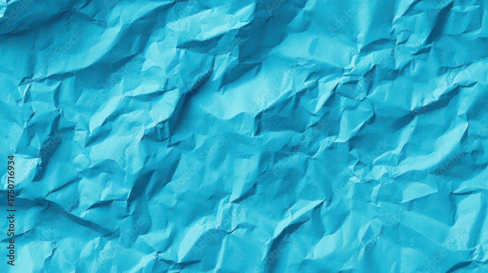 Fototapeta premium Bright crumpled blue surface creating an abstract textured background for creative designs