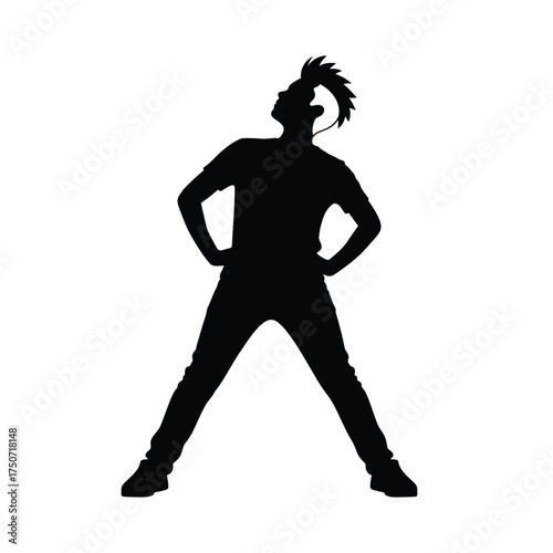 Silhouette of a man with a mohawk wearing a t shirt and jeans standing with hands on hips looking up