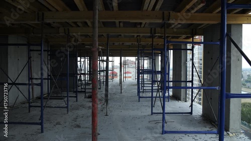Scaffolding and supports inside unfinished high-rise concrete building