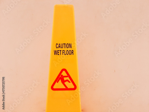 yellow sign that says wet floor or slippery floor