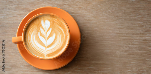 top view an orange mug with coffee latte art placed on wooden table, cozy cafe atmosphere captured in warm tones highlighting morning energy, artistic flatlay design and creative lifestyle detail