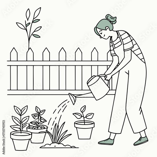 A young woman wearing overalls and a striped shirt happily waters small potted plants and a seedling in her garden with a watering can standing behind a white picket fence