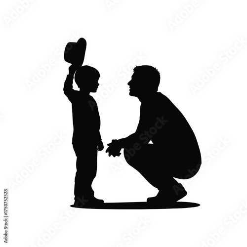 Silhouette of father crouching down looking at son holding hat up in the air on white background