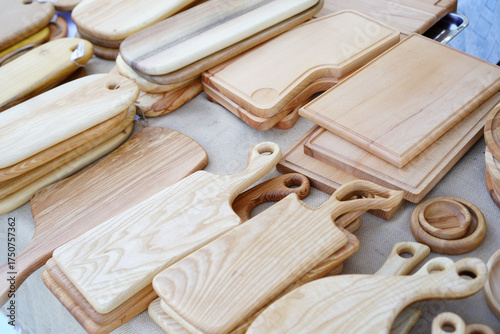 Unique collection of handmade wooden cutting boards displayed at a local craft market