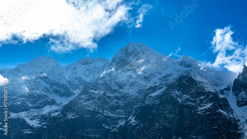 Fototapeta Naklejka Na Ścianę i Meble -  Snowy Mięguszowiecki Summit and Tatra Peaks under Dramatic Sky, Zakopane, Poland