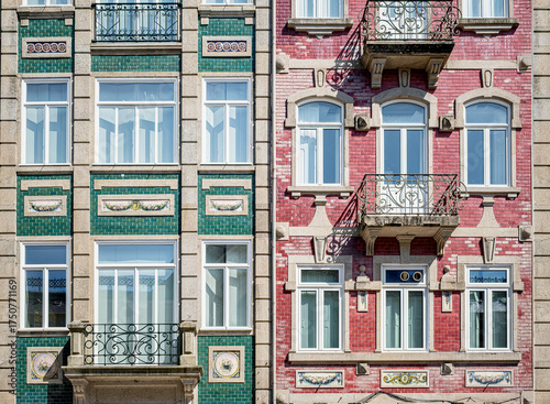 Colorful facade of traditional Portuguese buildings with green and red tiles, ornate balconies, and decorative details in bright daylight
