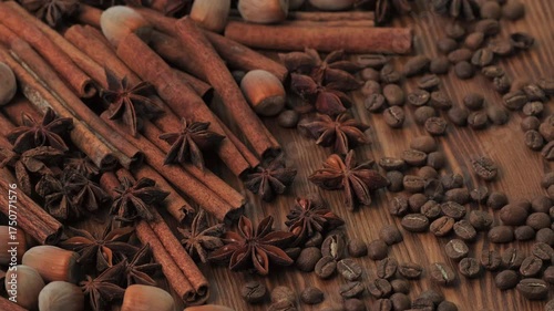 Christmas Aromatic Spices with Cinnamon, Star Anise and Coffee Beans Rotating on Wooden Table Creating Warm Festive Holiday Mood
