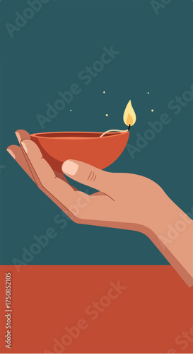 Hand holding a lit diya lamp, traditional oil lamp for Diwali festival.