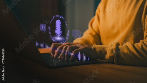 Person typing on laptop computer with glowing voice assistant icon, representing AI voice recognition, speech-to-text, and virtual assistant technology for modern communication and productivity.