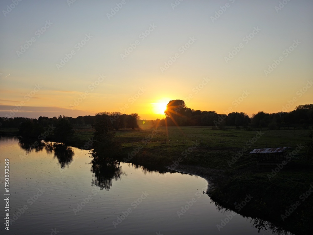 Obraz premium sunset over the river
