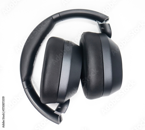 black headphones bent in photo with white background