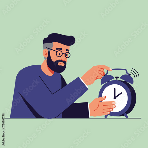 Bearded man shutting off ringing alarm clock on pale green background