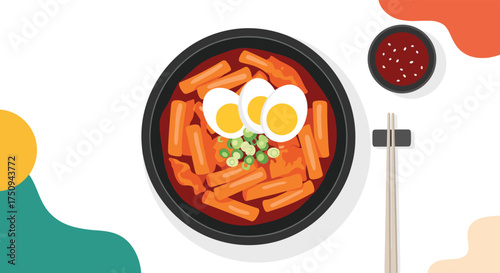 Delicious Korean rice cakes in spicy sauce with eggs and garnish.