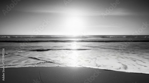 Serene Black And White Beach Sunset With Gentle Waves And Sparkling Ocean Reflections