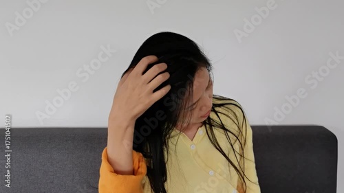 a woman had an itch on her head and scratched it by hand. health and medical concept