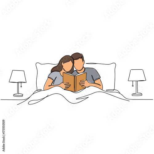 Couple relaxing in bed and reading a book together  
