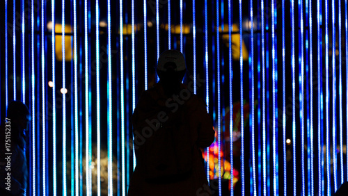 Fotografie Silhouette of people under the blue light beam