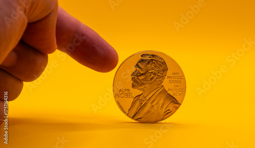 The gold medal of the Nobel Prize laureate on a yellow background