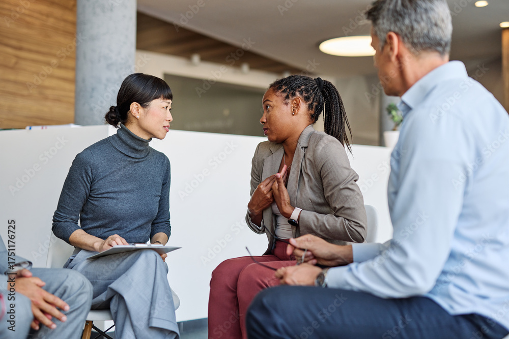 Obraz premium Group psychotherapy. Persons sitting in circle and talking. People meeting. Psychotherapy training, business lecture or conference. Man woman support group