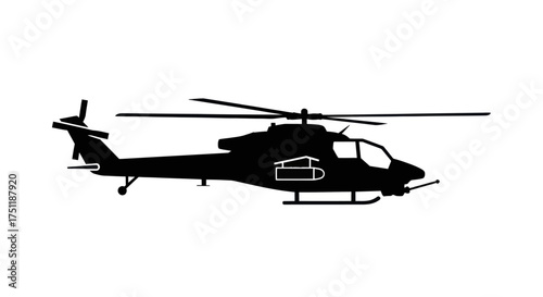 Silhouette of a military attack helicopter in flight.