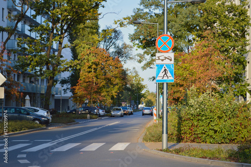 фотографія Urban Street Scene with Traffic Signs and Autumn Trees, Ursus