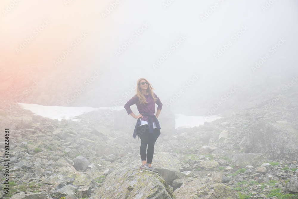 Naklejka premium A young girl watches the crater lake and mountains in the high altitude Kaçkar plateaus..