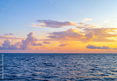 Sunset with sea. Colorful majestic scenery sunset sky with amazing clouds and waves. Beautiful sunset over sea landscape