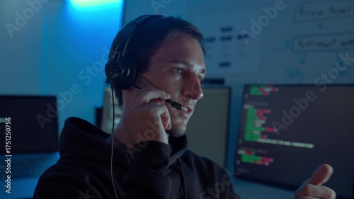 Professional IT support specialist wearing headset communicating with clients during night shift in call center office, showing reliability, remote assistance, and digital communication.