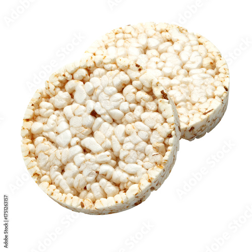 Two beige, round, puffed-grain snacks, possibly rice cakes, on a black background
