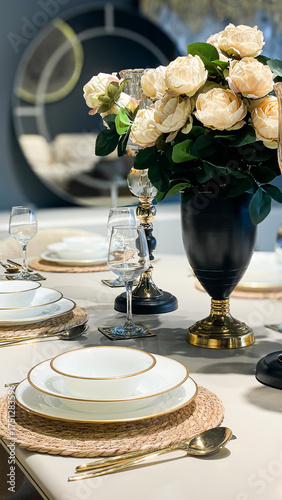 Fotografie Close-Up Of Elegant Table Setting With Gold-Trimmed Plates, Glassware, And Cream