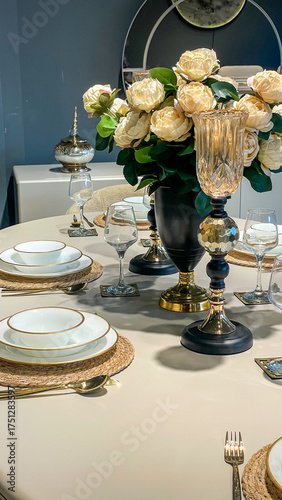 Obraz na plátně Elegant Dining Table Set With White And Gold Tableware, Wine Glasses, And Flower
