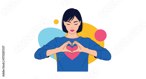 A woman forms a heart shape with her hands over a pink heart on her shirt.