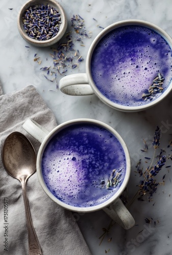 Lavender Latte Served in Two Mugs on a Marble Countertop With a Spoon and Dri...