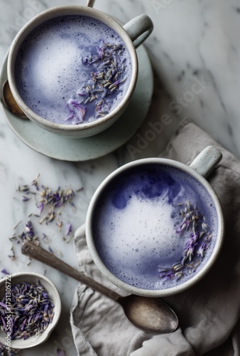Lavender Drinks With Frothy Milk and Dried Flowers on a Marble Surface Near a...