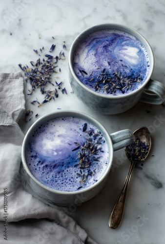 Lavender Latte Served in Two Mugs on a Marble Countertop With a Spoon and Dri...