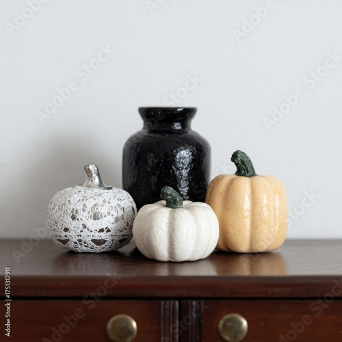 Decorative Pumpkins and Ceramic Vase on Wooden Surface