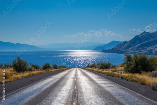 Scenic Road by the Sparkling Lake With Mountains in the Background on a Sunny...
