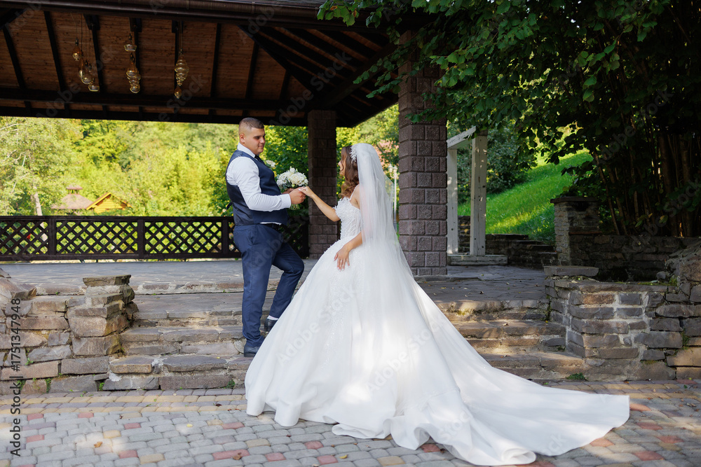 Fototapeta premium Couple exchanges vows in a beautiful outdoor setting during a summer wedding ceremony