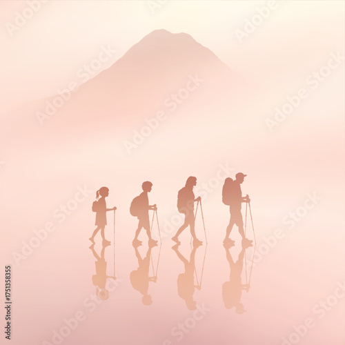 People with trekking poles. Family travel. Mountain silhouette in fog