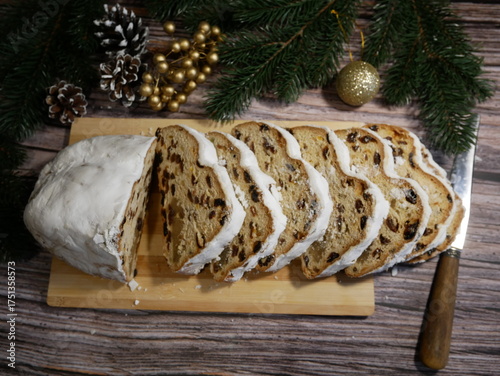Wallpaper Mural Traditional Sharden Christmas cake cut into slices on a festive table with holiday decorations. Cozy winter evening atmosphere at home. Christmas dessert and home baking concept Torontodigital.ca