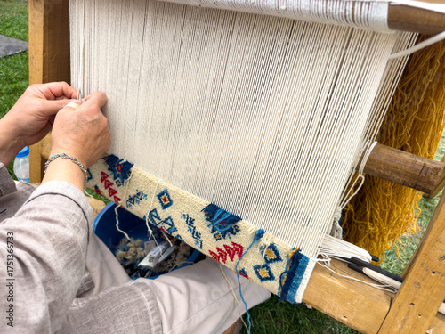 Carpet weaving using traditional techniques on a loom. , close-up of weaving and handmade carpet production.