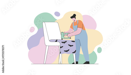 Person staples batpatterned fabric onto a chair illustrating DIY home decor or craft