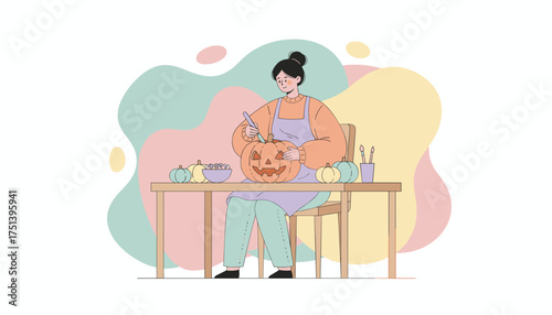 Woman carving a Halloween jackolantern enjoying seasonal autumn craft