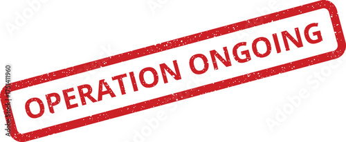 A rectangular distressed rubber stamp features text indicating an active continuous process or activity currently happening