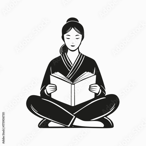 Woman sitting cross-legged reading a book peacefully