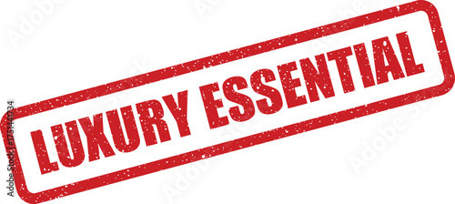 Industrial style textured rectangular stamp mark featuring the bold text LUXURY ESSENTIAL positioned on a slight diagonal slant