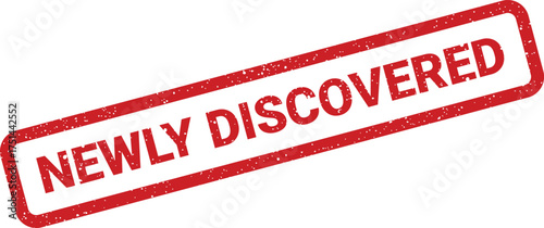 Rectangular distressed rubber stamp impression indicating a recently found item or new concept on a surface