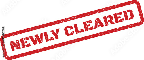 Textured red grunge stamp presenting the bold uppercase text NEWLY CLEARED for permission or security clearance